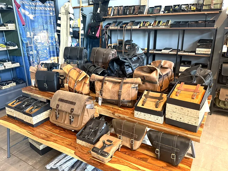 Leather bags and accessories on a table in the showroom