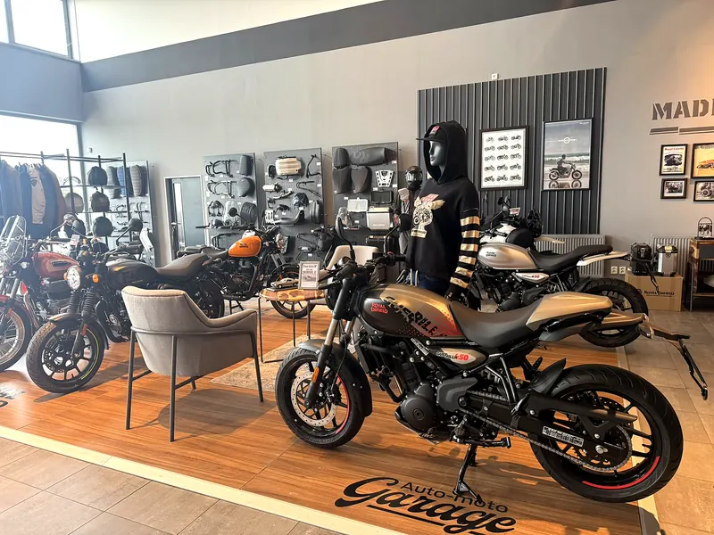A motorcycle on the GARAGE stage and armchairs