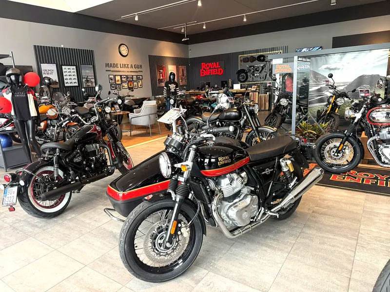 A red-and-black motorcycle in a row of machines