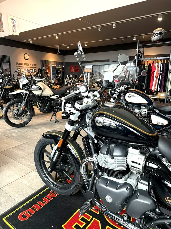 A motorcycle on a carpet with the Royal Enfield emblem