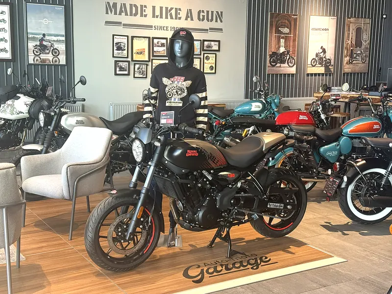A motorcycle on the GARAGE stage next to armchairs