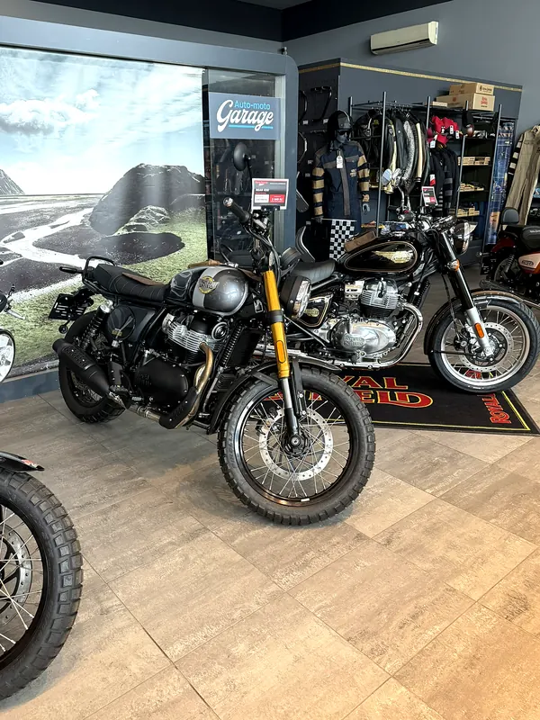 A motorcycle in front of a large landscape photograph