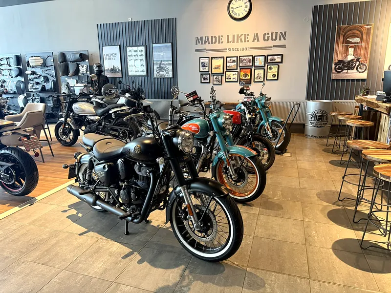 A row of Royal Enfield motorcycles and bar stools in the showroom